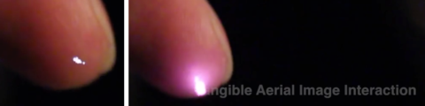 A finger is illuminated as it disrupts a few voxels of plasma