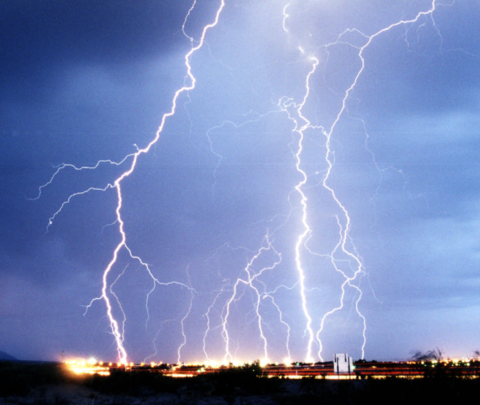 The flow of charge in a lightning bolt ionizes the air, producing the familiar flash.