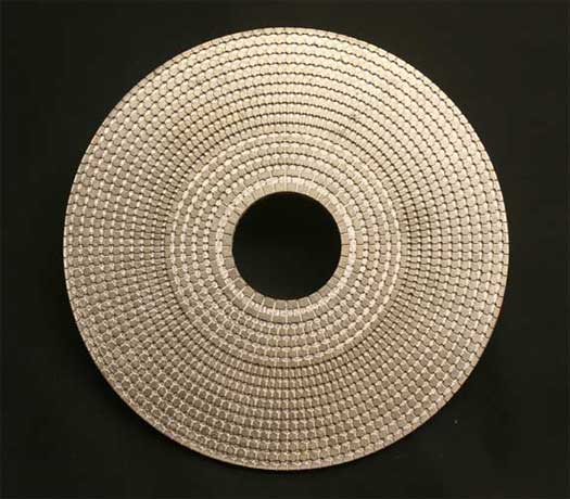 Image of a metamaterial whose structure allows us to control acoustic waves. It’s actual size is about the size of a computer or video disk. 