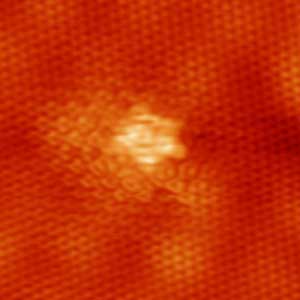 Ultra-high vacuum scanning tunneling microscopy image of a point defect in graphene.