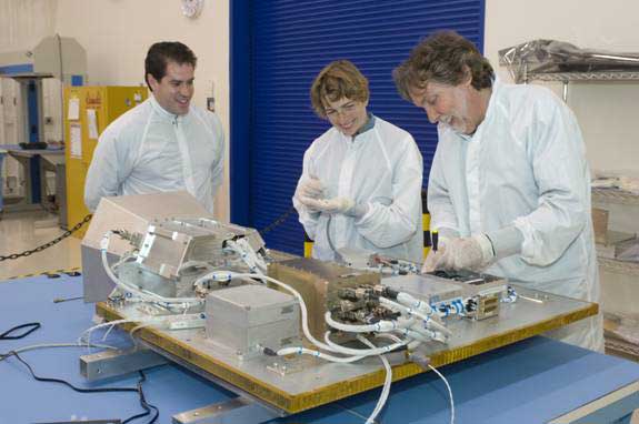 LCROSS flight hardware in clean room at NASA Ames Research with Left to right Tony Colaprete, LCROSS Principal Investigator, Kimberly Ennico, Payload Scientist, Co-Investigator Science team. Dana Lynch, Optical Engineer on LCROSS team Photo Credit: NASA Ames Research Center / Dominic Hart