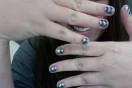 Showing off the effects of magnetic nail polish.