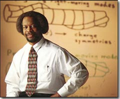 Jim Gates in front of physics drawings.