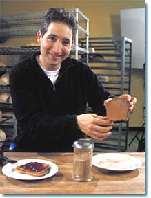 Brian Greene holding piece of bread.