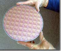 An 8 inch diameter wafer with strained silicon transistors fabricated on it.