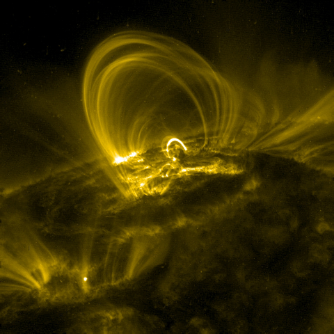 Plasma arcs from the surface of the sun, guided back down by powerful magnetic field lines.