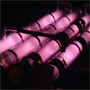 Low-pressure helium gas glows an eerie, soft pink color