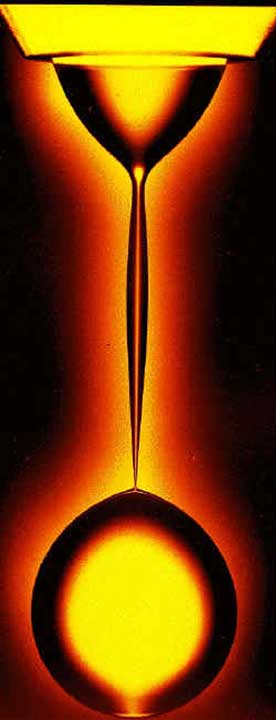 Physicist's lava lamp. Glycerin drips through a viscous oil, showing the details of pinching off in slow motion. Researchers have verified theories of the geometry at the point of snap-off (the narrowest point just above the spherical drop that has formed). Image credit: Phys. Rev. Lett. 83, 1147 (1999)