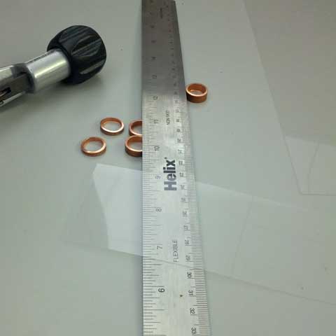 The transparency strip sits atop a pile of rings and the ruler