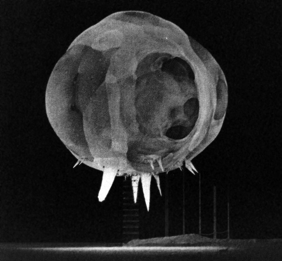 Milliseconds after detonation, spikes of bright light emanate from the bottom of a nuclear fireball.